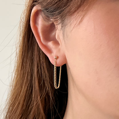 close up of model wearing 14k gold filled chain earrings