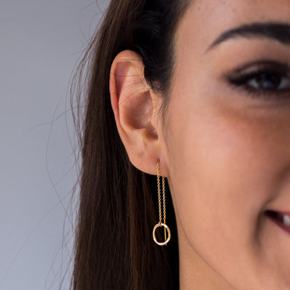 close up of model wearing 14k gold filled threader earring with hammered disc