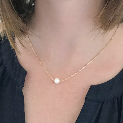 close up of model wearing Akoya pearl necklace