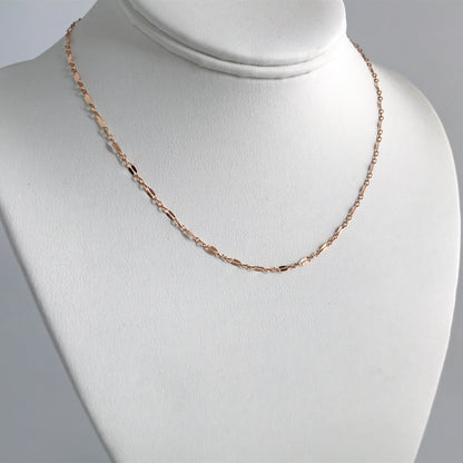 rose gold layering necklace on stand