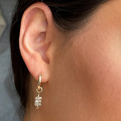 close up of model with hoop earirngs with crystals
