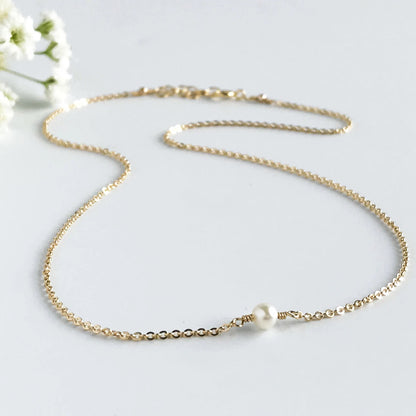 close up of Lucia Akoya pearl necklace on gold chain