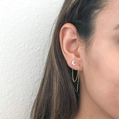 close up of model wearing moon stud for two hole earrings